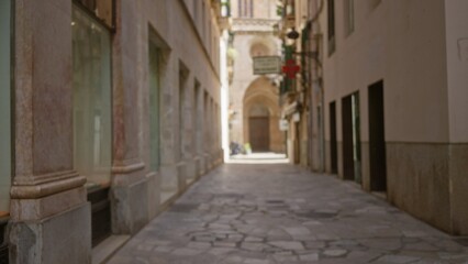 Fototapeta premium Defocused urban street in a european town, capturing the architectural charm with blurred buildings and bokeh effects.