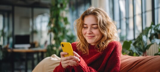 The woman enjoying her smartphone in a cozy indoor environment.