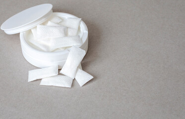 white container of Nicotine pouches on grey