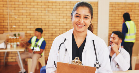 Doctor, clipboard and portrait of happy woman in community center for notes, charity or healthcare....