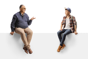 Teenager and a matue man sitting on a panel and having a conversation