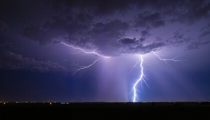 Dramatic lightning strike illuminating dark stormy night sky with copy space. Powerful lightning bolt illuminates night landscape offering ample space for text or design elements.