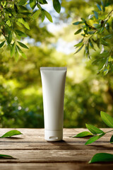 White tube of sunscreen placed on natural wooden table surrounded by lush green leaves, evoking sense of freshness and outdoor vitality