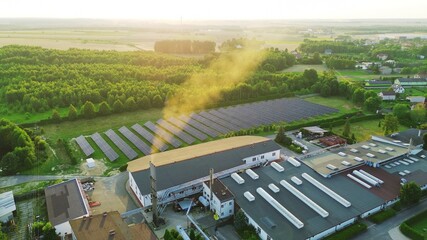 Solar energy farm beside factory buildings
