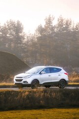 Fototapeta premium Modern SUV driving on countryside highway