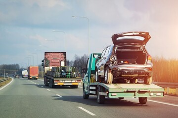 Highway towing service for wrecked automobile