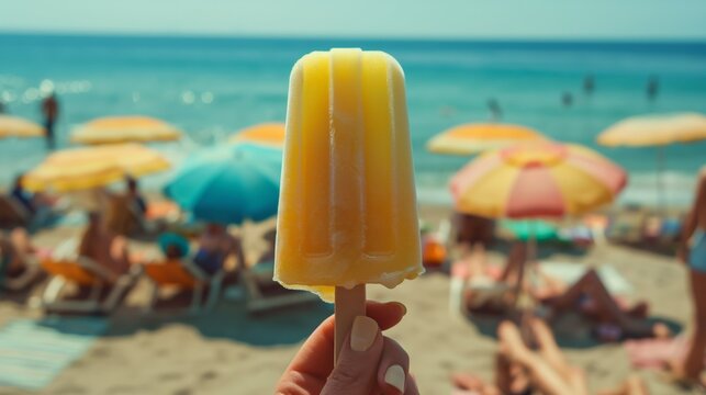 Lemon popsicle held by a hand at the beach with colorful umbrellas and people sunbathing, tropical summer scene, photorealistic close-up