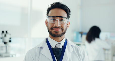 Man, scientist and happy with goggles, portrait or pride for career with medical research project. Person, smile and safety glasses for pharma study, vaccine development or ppe for eyes at laboratory