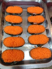 Close up of fried egg roll sushi in the market
