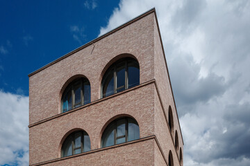 A low-angle view of a contemporary building in Berlin, Germany, constructed with light...