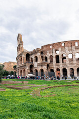 Fototapeta premium The iconic Roman Colosseum, a symbol of ancient Rome, stands majestically as tourists gather to admire its grandeur
