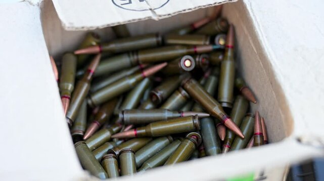 Combat preparation at a military training ground. This footage shows a close-up of a box full of rifle cartridges, highlighting the logistics and munitions supply for armed forces exercises in Ukraine