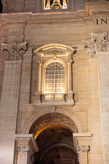 A nighttime view of the illuminated fountain in St. Peter’s Square, Vatican City, with cascading...