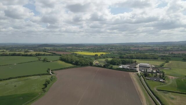 Arial view of Stogursey parish in the quantock hills Somerset. Drone moving forward over the fields and in direction to the quantock hills.