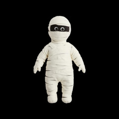 A white stuffed toy with a black face and a black bandage around its neck. The toy is dressed in a costume that resembles a mummy