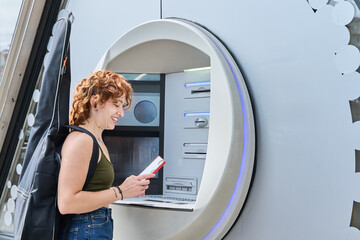 Musician withdrawing money using smartphone at atm