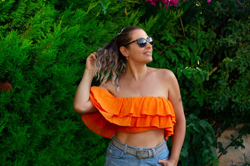 portrait of a beautiful young woman smiling at camera  in the garden