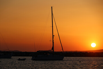 Sailboat at sunset in the harbor of the Cycladic island of Naxos - Greece