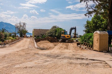 Roadwork site near the coastline. Urban development, infrastructure maintenance, and heavy...