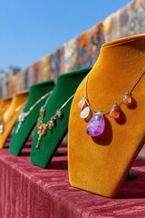 Artisan Necklaces with Gemstones on Display at Sunny Outdoor Market