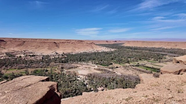 Ziz canyon, Morocco: Panorama of the dramatic Ziz canyon with a palm tree plantation and ancient village in the Atlas mountain on the road between Merzouga and Fes in Morocco