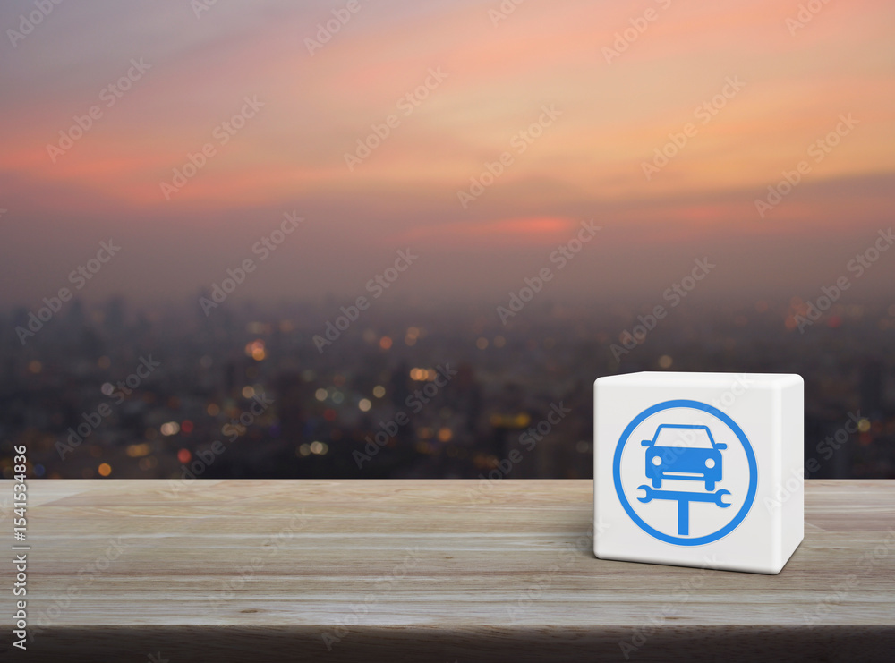Aufkleber service fix car with wrench tool icon on white block cube on wooden table over blur of cityscape on 