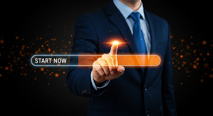 A businessman in suit touching a start now button with orange glow on a dark background with sparkles