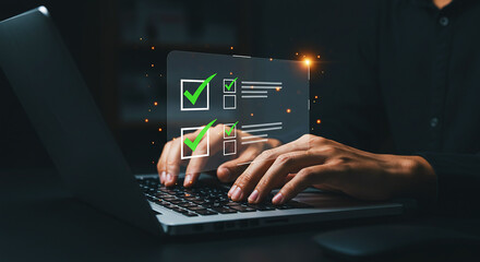 A person completing a digital checklist on a laptop with green checkmarks on the screen shown clearly