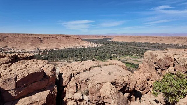 Ziz canyon, Morocco: Panorama of the dramatic Ziz canyon with a palm tree plantation and ancient village in the Atlas mountain on the road between Merzouga and Fes in Morocco