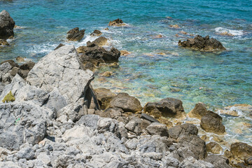 Picturesque beach with turquoise water and massive rocks in Crete