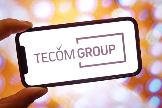Konskie, Poland - April 12, 2025: TECOM Group company logo displayed on mobile phone