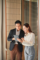 Mentor coaching new office trainee under supervision of senior employee in company workplace...