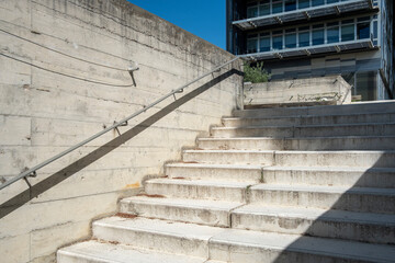 Urban staircases with strong concrete lines and ascending rhythm, designed background space with architectural structure and copyspace
