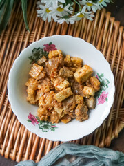 A bowl of Sambal Goreng Pengantin, a rich, traditional Malay dish made from a combination of beef liver, lung, trimmings, spleen, prawns, tofu, and tempe in coconut gravy, perfect for festive meals.
