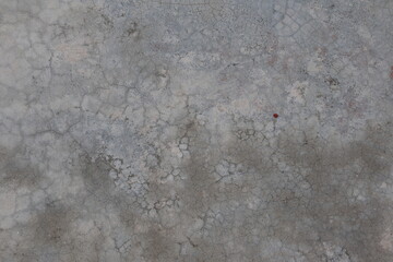 Close-up of a weathered concrete surface with rough texture and gray tones