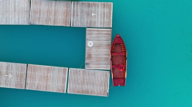 Lago di Braies or Lake Braies crystal blue lake with wooden rowing boats in Italian Dolomites, Overhead aerial view