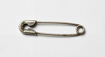 Vintage safety pin on a clean background for sewing and crafting concept