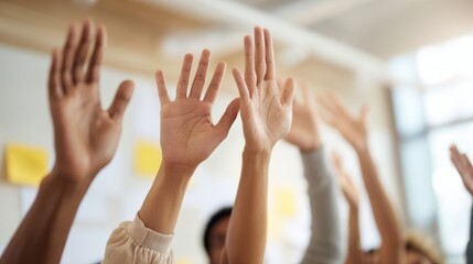 The hands of eager participants raised in a collaborative learning environment.