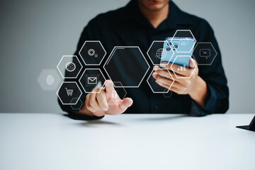 Real person interacting with futuristic UI on a smartphone. Floating hexagon icons for apps, mail, lock, and shopping.