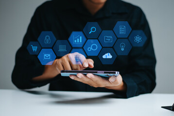 Real person interacting with futuristic UI on a smartphone. Floating hexagon icons for apps, mail, lock, and shopping.