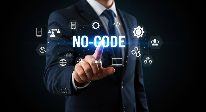 A man in a suit pointing at no code text with icons floating around on a dark background display screen