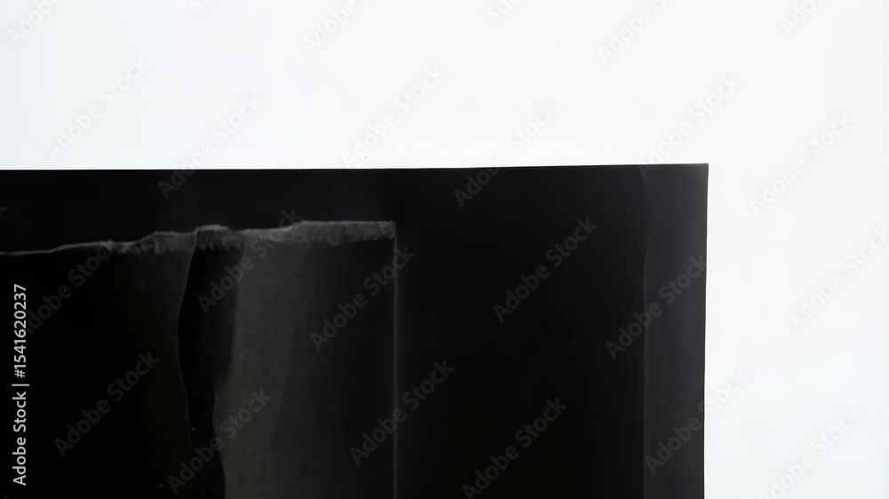 Poster torn black paper with white background showing a scroll and jagged edges creating a minimalist graph