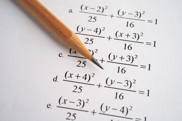Pencil on mathematic formula exercise test paper in education school.