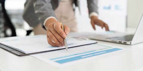 Data Entry and Management. Business professional organizing financial reports on desk.