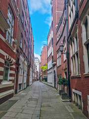 Tiny street in London with traditional brick buildings and facades, London, England, United Kingdom