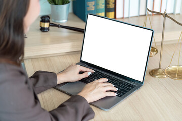 Lawyer Working on Laptop. A professional woman typing on a laptop in her modern office.