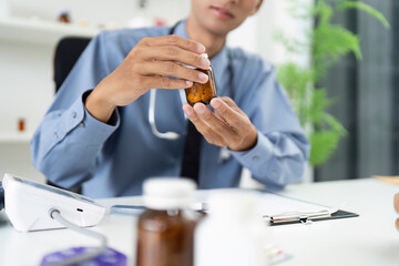Healthcare Consultation. Doctor discussing medication with patient in modern office.