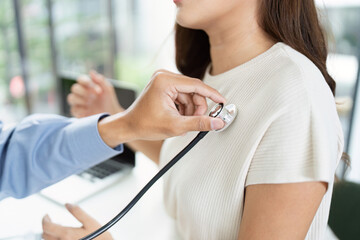 Routine Health Check. Doctor using stethoscope to examine a patient.