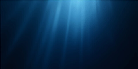 Bright sun rays burst through the deep blue ocean, illuminating a serene underwater world background