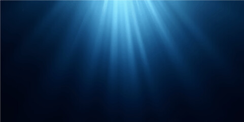 Bright sun rays burst through the deep blue ocean, illuminating a serene underwater world background